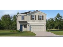 Charming two-story home featuring a two-car garage and well-manicured lawn at 979 Hour Glass Rd, Lakeland, FL 33801