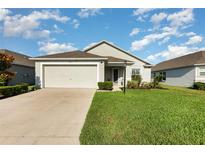 Charming single-story home featuring an attached two-car garage and lush, green lawn at 6050 Eagle Pointe Dr, Lakeland, FL 33812