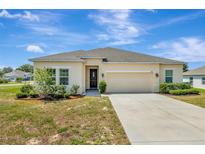 Charming single-story home with a well-maintained lawn and a two-car garage at 1803 Daybreak Dr, Fruitland Park, FL 34731