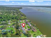 Aerial view of waterfront homes along canal with lush greenery and access to the river at 718 Cr 467, Lake Panasoffkee, FL 33538