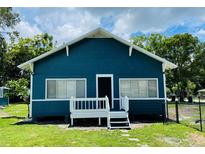 Charming blue and white cottage-style home with a small front porch and well-maintained lawn under a partly cloudy sky at 2915 Winter Lake Rd, Lakeland, FL 33803