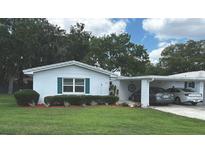 Charming single story home featuring a well-manicured lawn and covered parking at 730 Barber Cir, Lakeland, FL 33803
