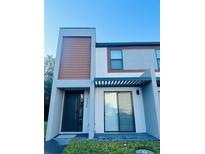 Modern two-story home with minimalist landscaping and striking architectural details at 3428 Tranquil Trail, Kissimmee, FL 34747
