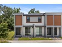 Modern townhome with a neutral color scheme, offering a stylish and contemporary curb appeal at 3428 Tranquil Trail, Kissimmee, FL 34747