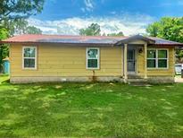 Quaint single-story home with a red roof, awaiting your personal touch at 2220 Woods Trl, Lakeland, FL 33809