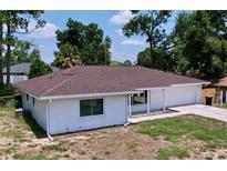 Charming single-story home featuring a brick exterior, new brown roof, attached garage and well-maintained landscaping at 212 Overlook Dr, Winter Haven, FL 33884