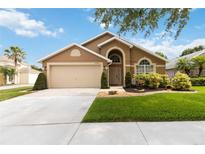 Charming single-story home with a well-maintained lawn and two-car garage at 8360 Lake Amhurst Trl, Orlando, FL 32829