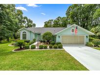 Charming single-story home with a well-maintained lawn, landscaping, and a two-car garage at 9530 Sw 189Th Ct, Dunnellon, FL 34432