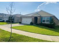 Charming single-story home with a well-manicured lawn and attached two-car garage, and neutral color scheme at 3974 Mekong Ct, St Cloud, FL 34772