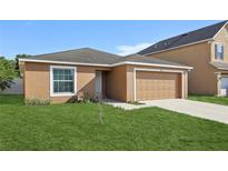 Charming single-Gathering home with a well-manicured lawn and a single-car garage at 109 James Cir, Lake Alfred, FL 33850