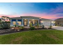 Charming single-story home features a well-manicured lawn, desert landscaping, and a three-car garage at 10298 Sw 96Th Loop, Ocala, FL 34481
