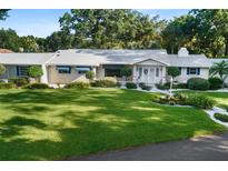 Charming single-story home with a pristine front lawn and beautiful landscaping at 2110 Reaney Rd, Lakeland, FL 33803