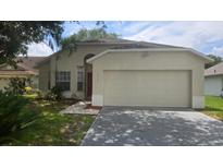 Charming single-story home with well-maintained lawn and a two-car garage at 1416 Silverthorn Dr, Orlando, FL 32825