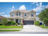 Charming two-story home with a well-manicured lawn, two-car garage and welcoming front porch at 2283 Geneva Dr, Lakeland, FL 33805