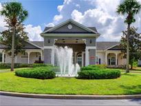 Elegant clubhouse entrance featuring a beautiful fountain and well-manicured landscaping at 3175 Feltrim Pl # 405, Kissimmee, FL 34747