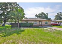 Charming single-story home with a well-manicured lawn and mature trees at 1110 Waterview E Blvd, Lakeland, FL 33801