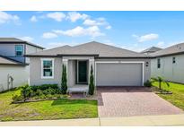 Charming single-story home featuring a two-car garage and a well-manicured lawn at 2296 Crossbow St, Clermont, FL 34715