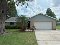 Charming single-story home with brick accents, a two-car garage, and a well-maintained front yard at 4221 Meadowbend Ct, Lakeland, FL 33811