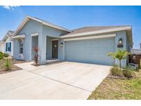 Beautiful one-story home with a large two car garage and well maintained landscaping in the front yard at 621 Silver Palm Dr, Haines City, FL 33844