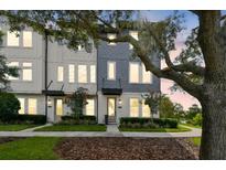 Charming townhome showcases manicured landscaping and a welcoming entryway at 12684 Willstatter Ave, Orlando, FL 32827