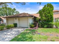 Charming single-story home features a well-manicured lawn and attached two-car garage at 940 Fenton Ln # 7, Lakeland, FL 33809