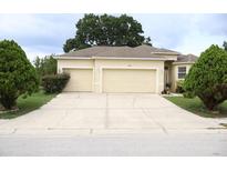 Charming single-Gathering home with a three-car garage and well-maintained landscaping at 7055 Heatherbrook Dr, Lakeland, FL 33809