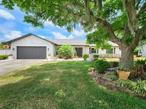 Charming single-story home featuring mature landscaping and a well-maintained front yard at 4102 Stonehenge Rd, Mulberry, FL 33860