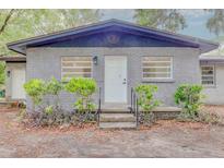 Charming single-story home featuring a gray brick exterior, well-maintained landscaping, and a welcoming front entrance at 1255 Pine St, Altamonte Springs, FL 32701