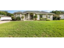 Charming one-story home featuring a well-maintained lawn, mature trees, and inviting curb appeal at 629 Orange Valley Ln, Lakeland, FL 33813
