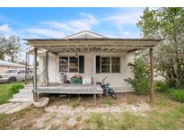 Charming single-story home featuring a covered front porch and a low-maintenance yard at 303 Clayton Rd, Auburndale, FL 33823