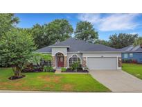 Charming single-story home with well-manicured lawn and mature landscaping at 3897 Beacon Ridge Way, Clermont, FL 34711