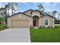 Charming single-story home with a well-manicured lawn, attached garage, and neutral color palette at 27 Perch Dr, Kissimmee, FL 34759