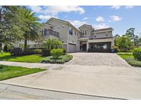 Stunning two-story home featuring lush landscaping and a circular driveway, blending elegance with curb appeal at 9080 Morgana Ct, Winter Garden, FL 34787