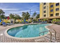 Inviting outdoor pool area surrounded by lounge chairs for relaxation and sunbathing at 7601 Canada Ave # 220, Orlando, FL 32819