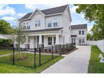 Charming two-story home with a well-maintained lawn and a classic black metal fence at 216 E Harding St, Orlando, FL 32806