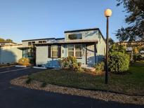 Charming light blue exterior with decorative landscaping and black shutters offers appealing curb appeal at 85 Heather Point Ct # 850, New Smyrna Beach, FL 32169
