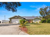 Charming single-story home with well-maintained lawn, landscaping, and a two-car garage at 6143 Black Walnut Dr, Bartow, FL 33830