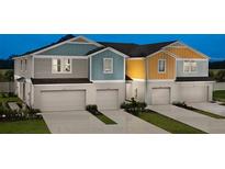 Charming multi-colored townhomes feature attached garages and modern architectural details at 3759 King Hill Dr, Haines City, FL 33844