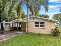 Charming single-story home with a covered parking area and lush landscaping at 1740 Inman Nw Dr, Winter Haven, FL 33881