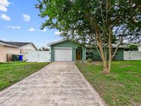 Charming one-story home featuring a well-maintained front yard and a spacious driveway leading to a two-car garage at 1238 Honeytree E Ln, Lakeland, FL 33801