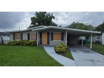 Modest single-story home featuring a covered carport and a well-maintained lawn at 1864 Williams Manor Ave, Orlando, FL 32811
