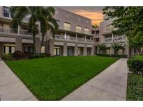 Beautiful courtyard with green grass and sidewalks surrounded by apartments with balconies at 539 Water St # 539, Kissimmee, FL 34747