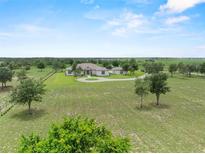 Expansive aerial view of a stately home on a large lot with mature trees and circular driveway at 9419 Alturas Babson Park Cutoff Rd, Bartow, FL 33830