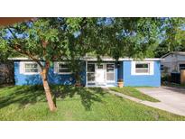 Charming single-story home with a well-maintained lawn and mature landscaping at 2506 Bonneville Dr, Orlando, FL 32826