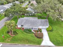 Charming single-story home features manicured lawn, mature trees, and a welcoming front porch at 5402 Rosewall Cir, Leesburg, FL 34748