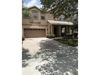Charming two-story home with a well-manicured lawn and a welcoming front porch at 310 Stakes Ct, Deland, FL 32724