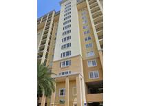 Exterior view of tall building, with multiple floors, balconies, and decorative columns at 8125 Resort Village Dr # 5902, Orlando, FL 32821