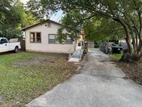 Charming single-story home with a long driveway and mature trees at 5418 Brownell St, Orlando, FL 32810