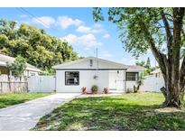 Charming single-story home with a well-manicured lawn and a white picket fence at 1304 E Myrtle St, Lakeland, FL 33801