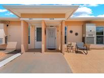 Inviting condo entrance featuring covered porch, seating, and a welcoming 'Welcome' sign at 4209 Club Cir, Lakeshore, FL 33854